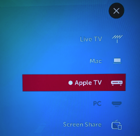An image showing the input selection menu on a TV, with the Apple TV input selected