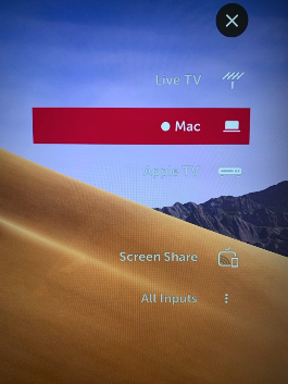 An image showing the input selection menu on a TV, with the Mac input selected